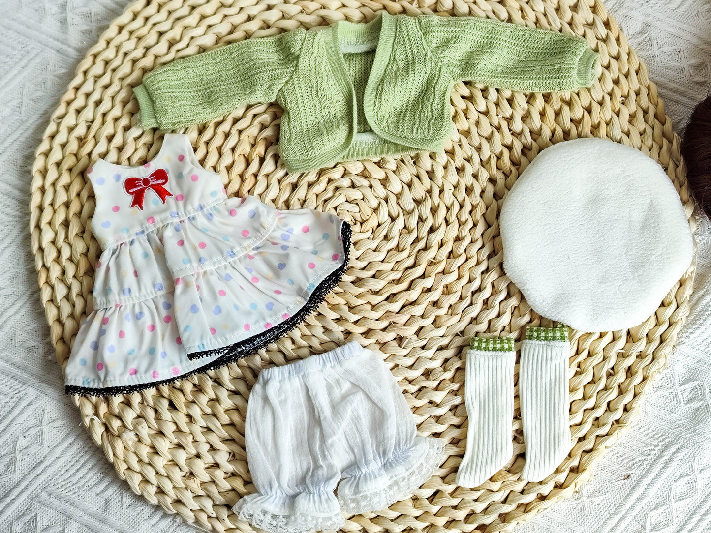 Handmade polka dot dress, green cardigan, and beret flat lay for BJD.