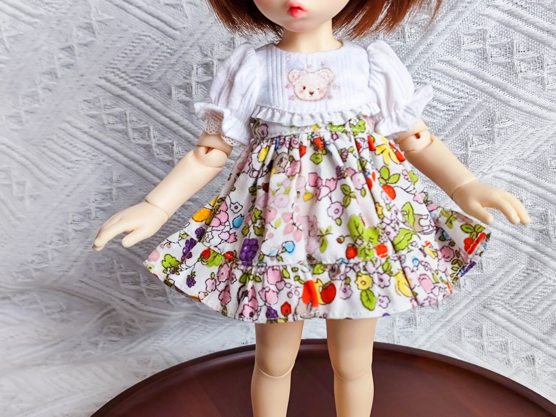 Detail view of 1/6 BJD YoSD doll clothes, floral print skirt and ruffled hem.