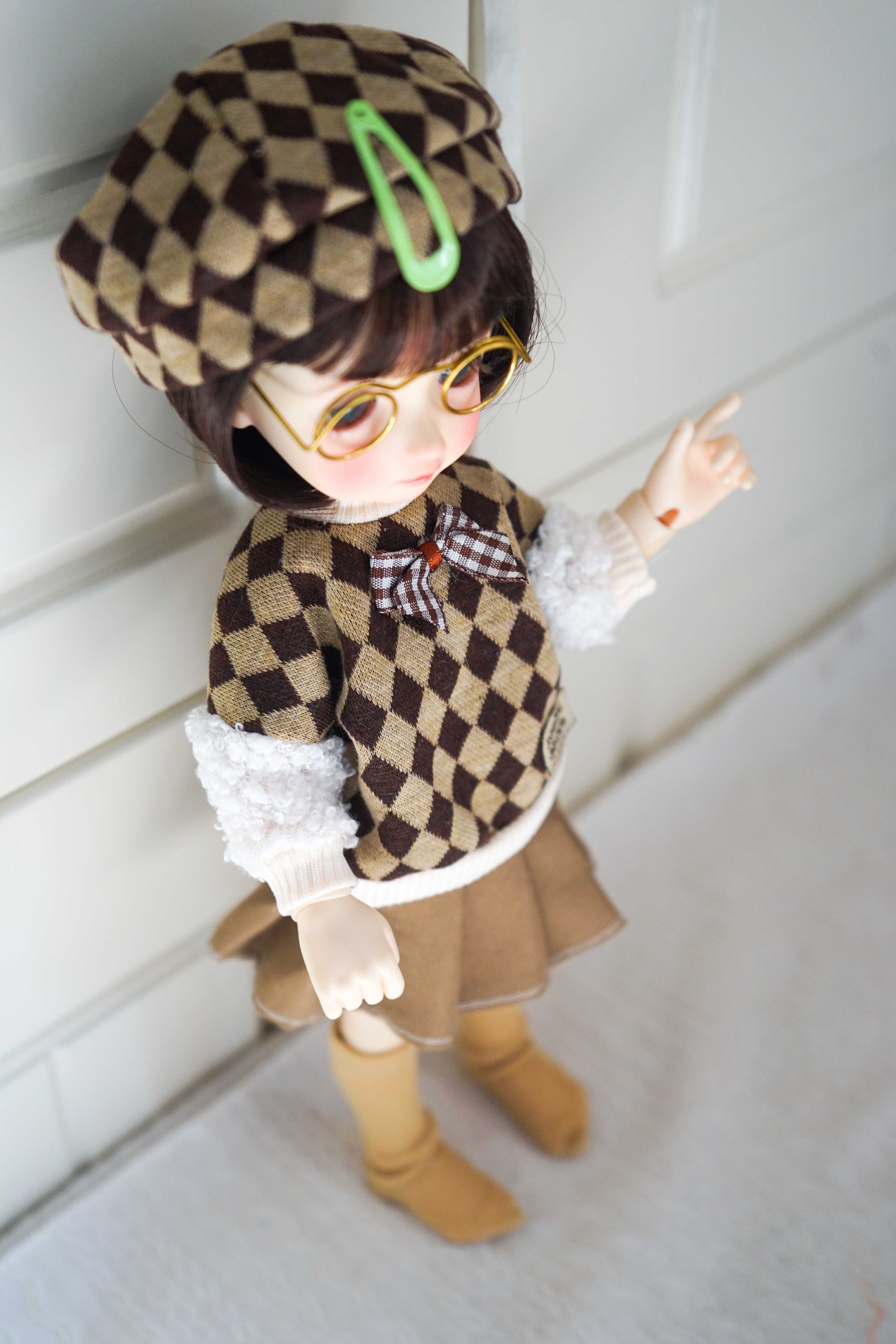 Close-up side detail of handmade argyle knit vest for 1/6 BJD.