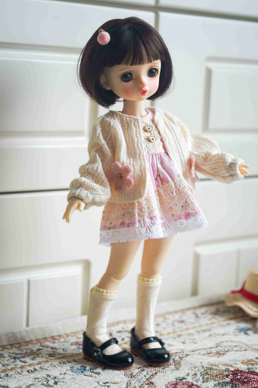 1/6 BJD YoSD doll wearing a handmade bear ear knit cardigan and floral pinafore set.