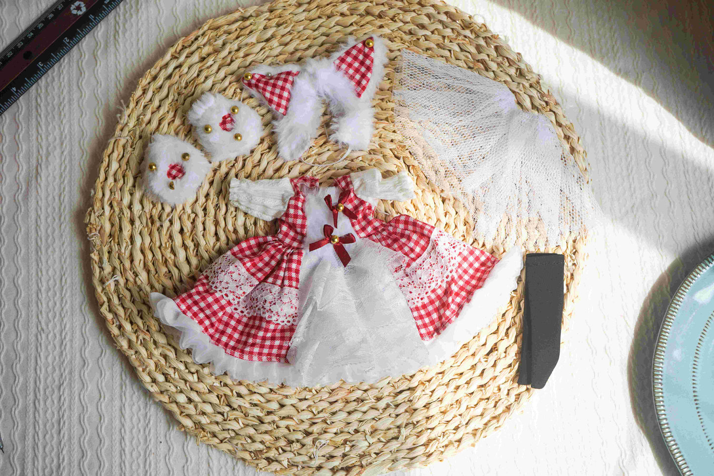 Flat lay photography of a complete 1/6 BJD Lolita outfit including dress, cat ears, and paw gloves.