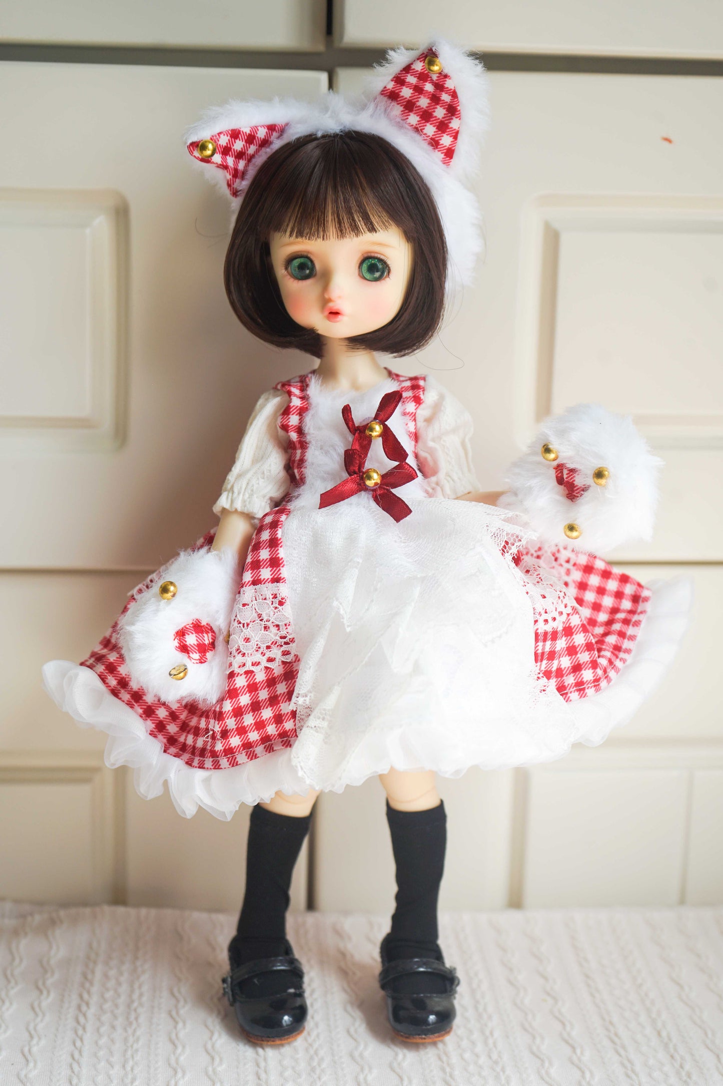 1/6 BJD YoSD doll wearing a handmade red gingham Lolita princess dress with cat ears and paw gloves.