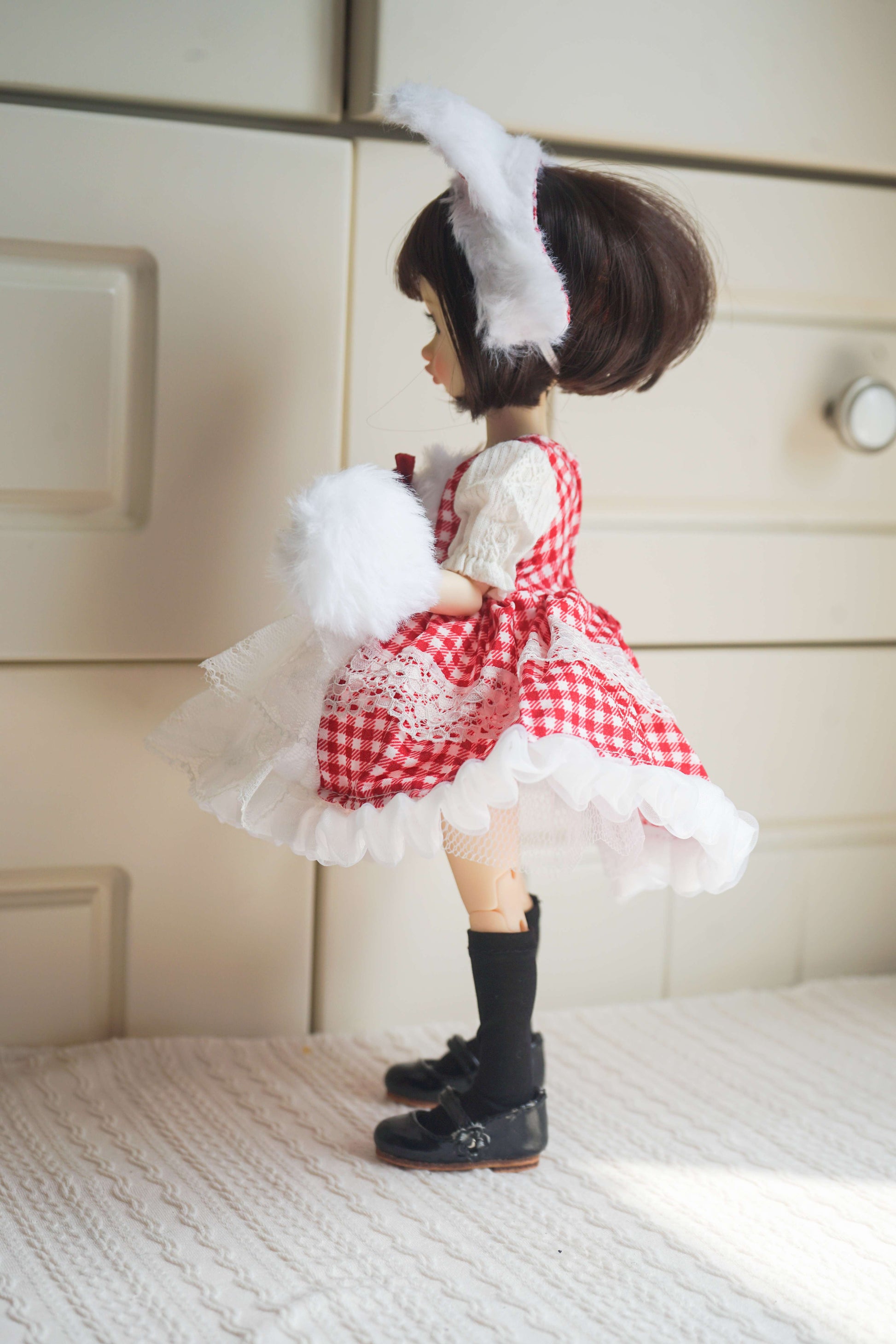 Side profile of a 1/6 BJD doll showcasing the cat ear headwear and layered lace dress.