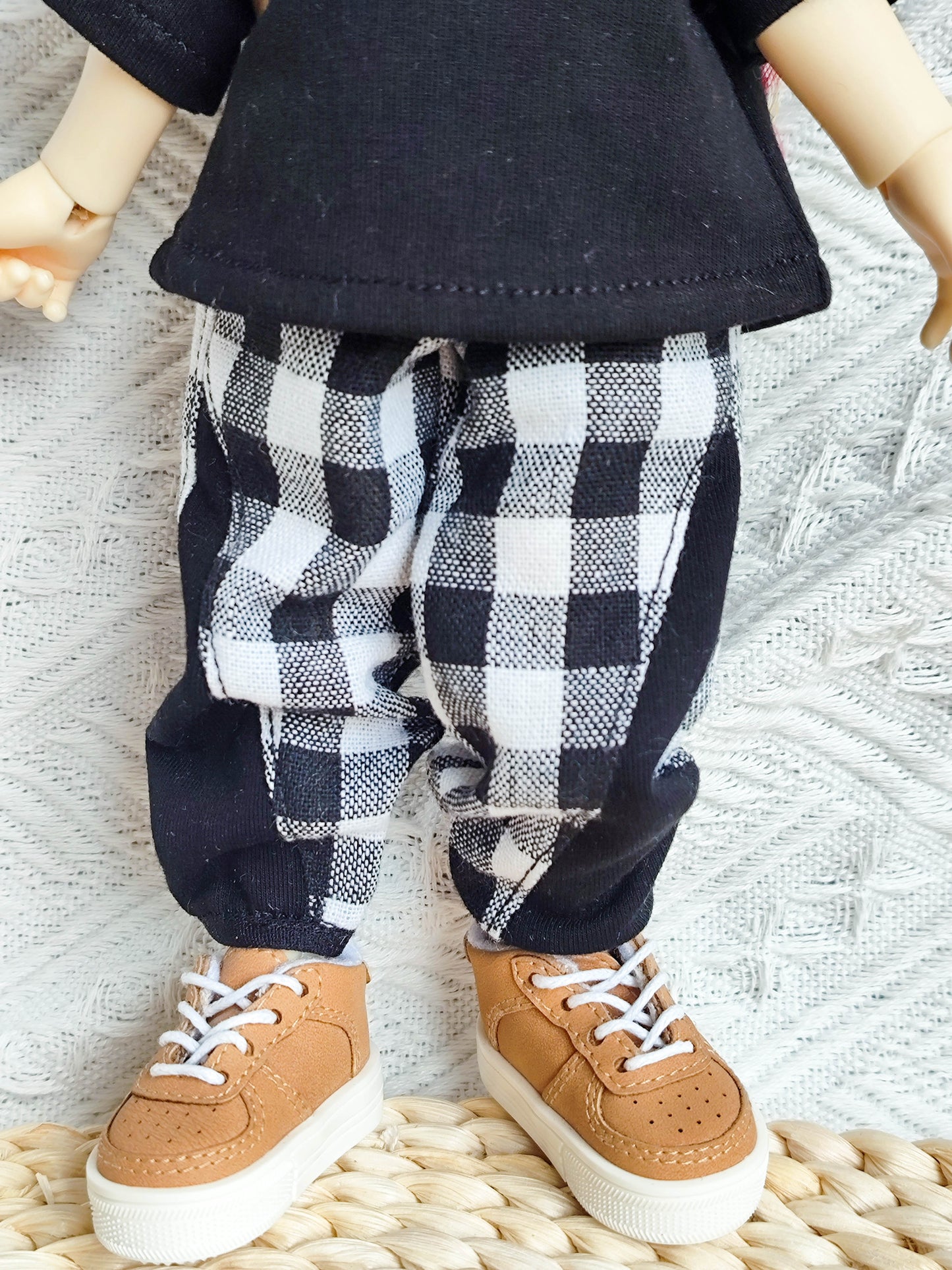 Close-up of the checkered pants and sneakers on a 1/6 BJD doll.