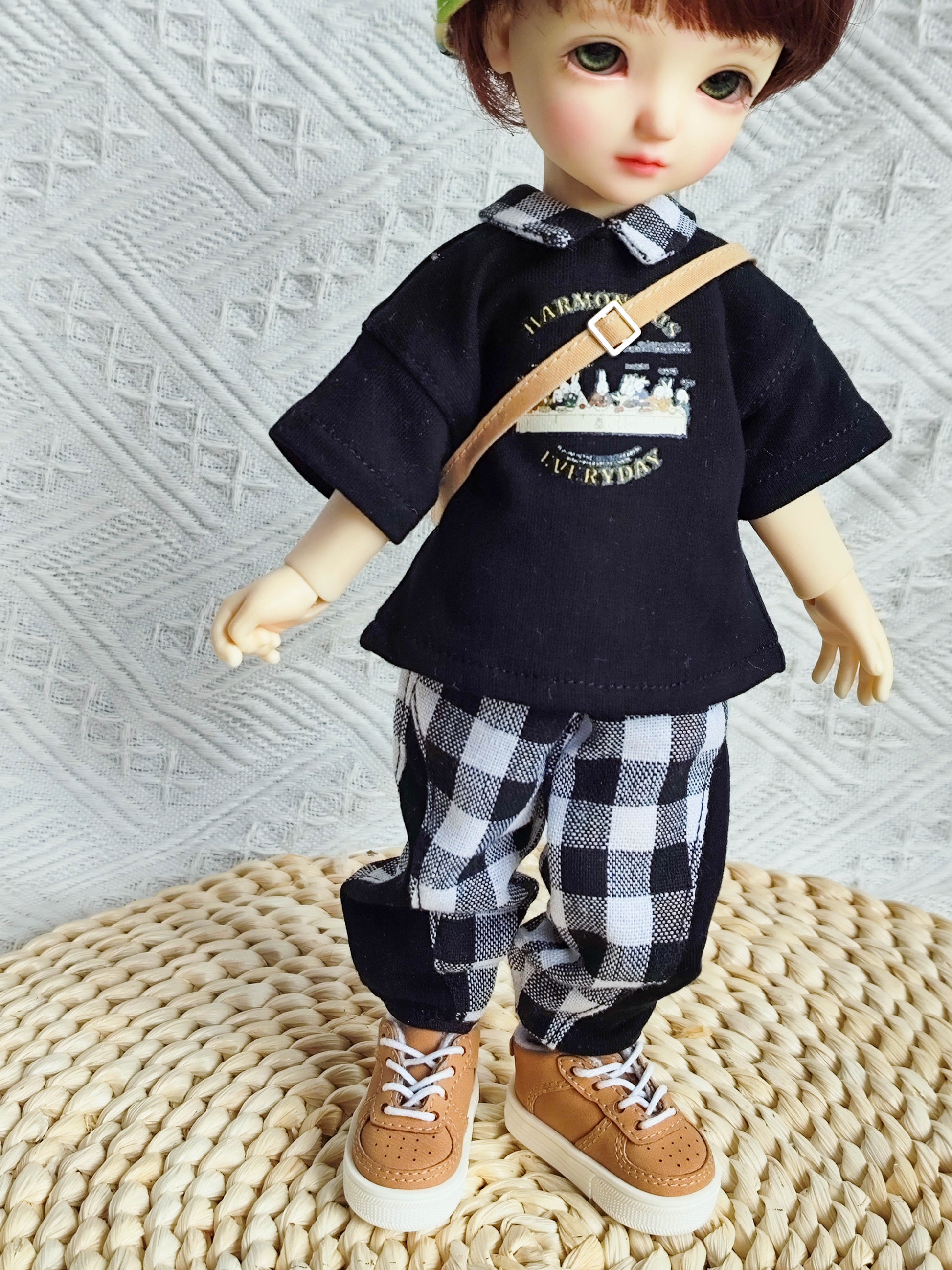 Close-up upper body view of a 1/6 BJD doll in a preppy graphic t-shirt.