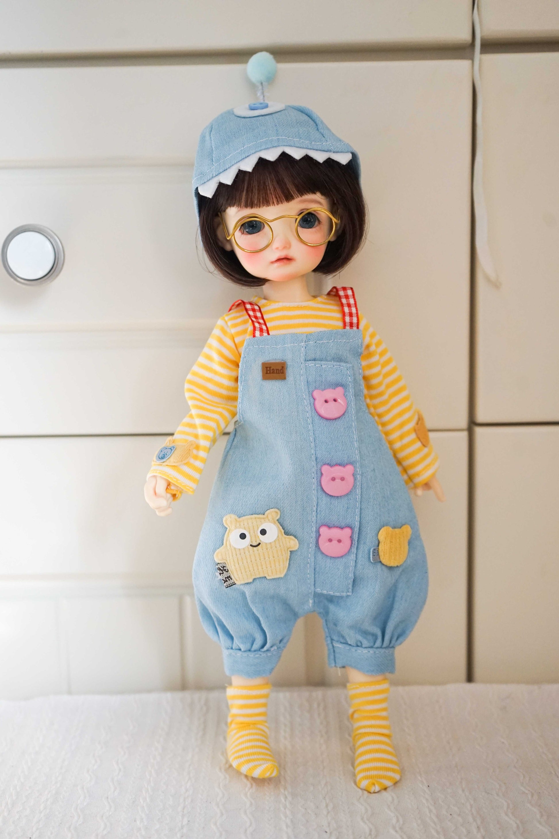 Front view of a 1/6 BJD YoSD doll wearing a shark hat and denim overalls outfit.