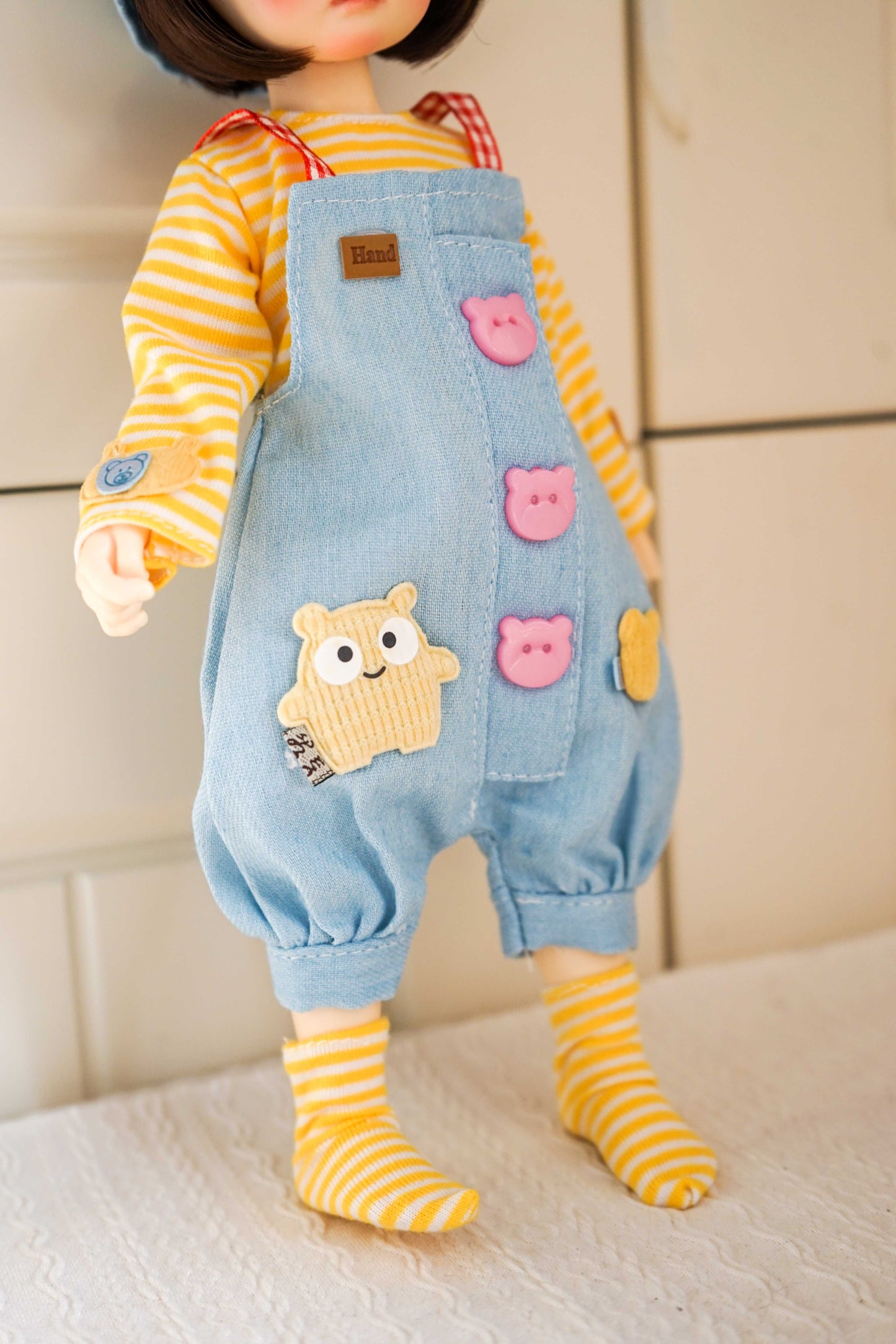 Close-up of the lower section of handmade denim overalls for 1/6 scale BJD doll clothing.