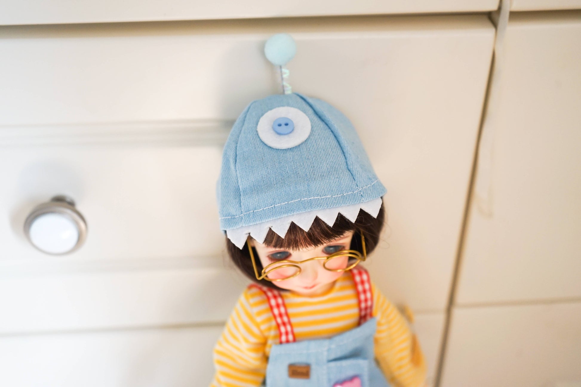 Top view detail of a handmade blue shark hat for 1/6 scale BJD doll clothes.