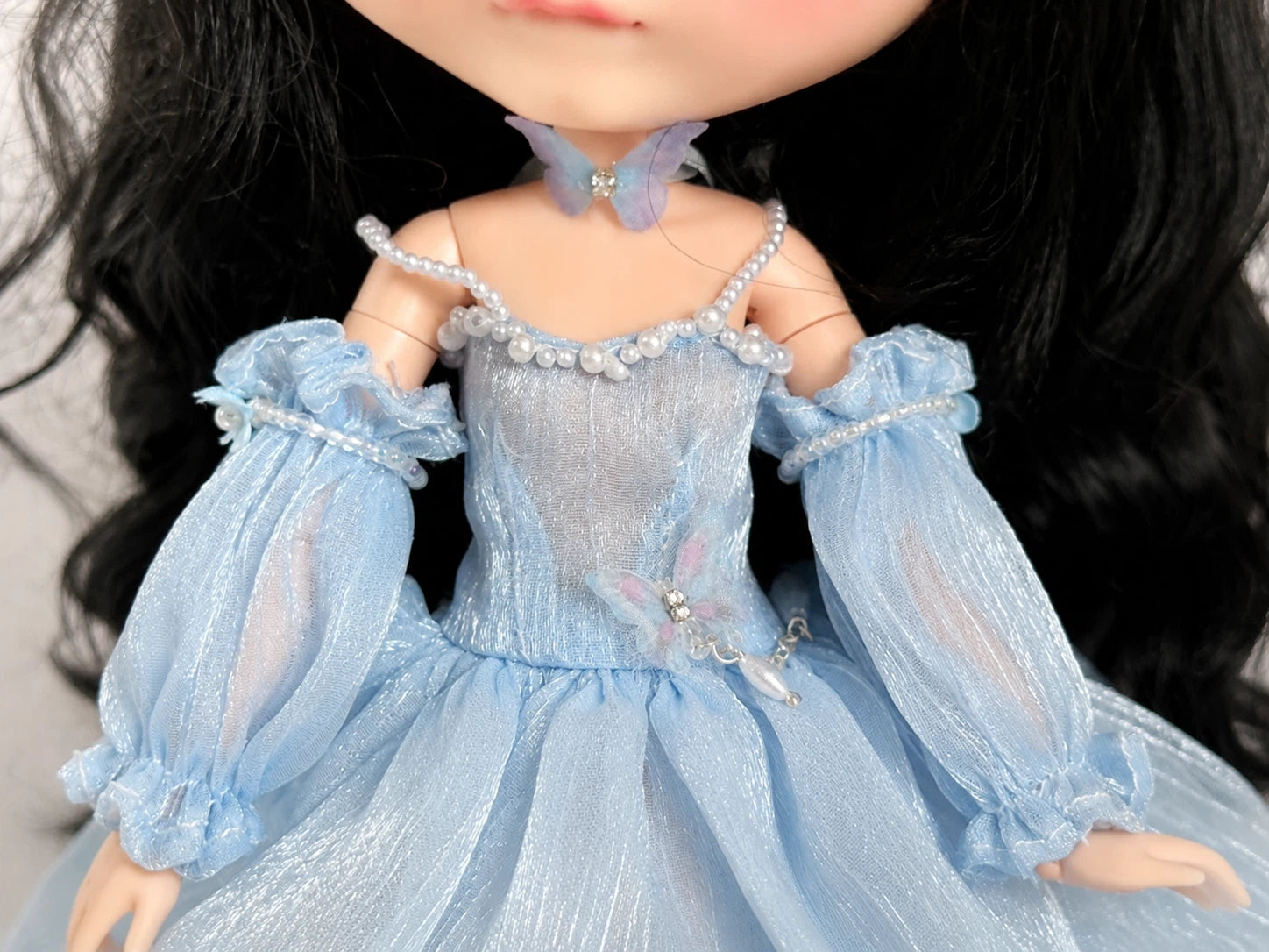 Detailed view of delicate lace and tulle embroidery on Blythe fairy dress.