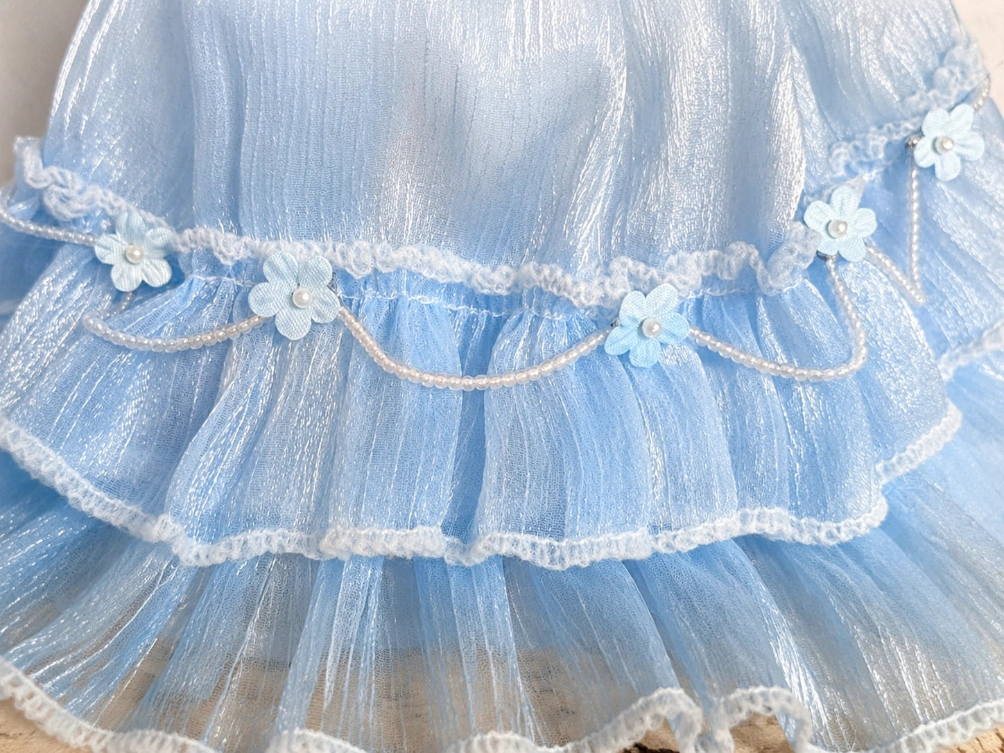 Detailed view of layered tulle skirt and hem on blue Blythe fairy dress.