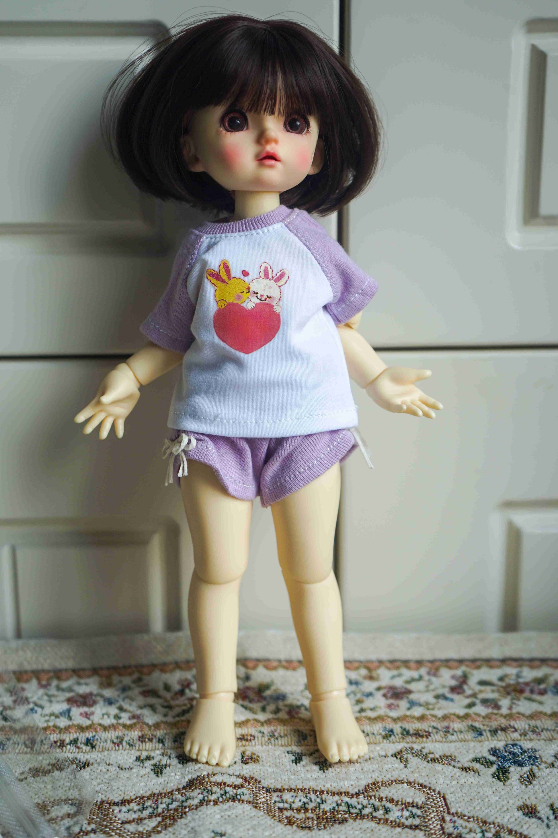 A 1/6 BJD YoSD doll wearing the handmade casual cartoon raglan T-shirt and shorts set.
