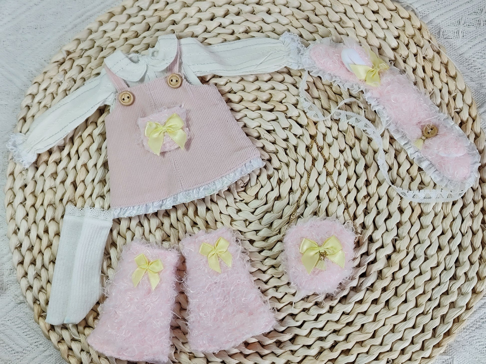 Product flat lay of the handmade fluffy corduroy pinafore set and furry headband for 1/6 BJD dolls.