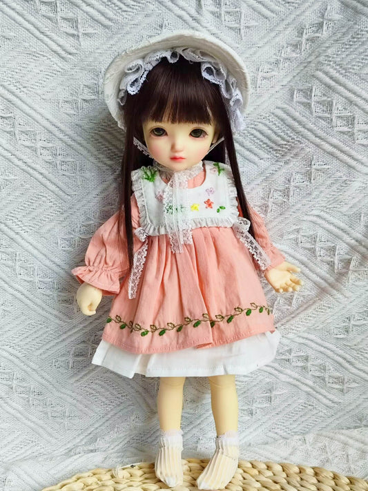 1/6 BJD YoSD doll wearing a handmade cottagecore floral embroidered dress and Victorian bonnet.