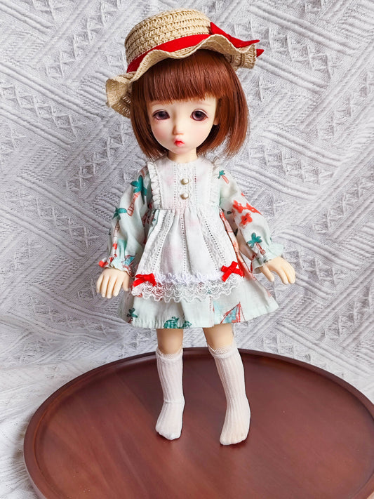 1/6 BJD YoSD doll wearing a handmade cottagecore floral prairie dress and lace apron set