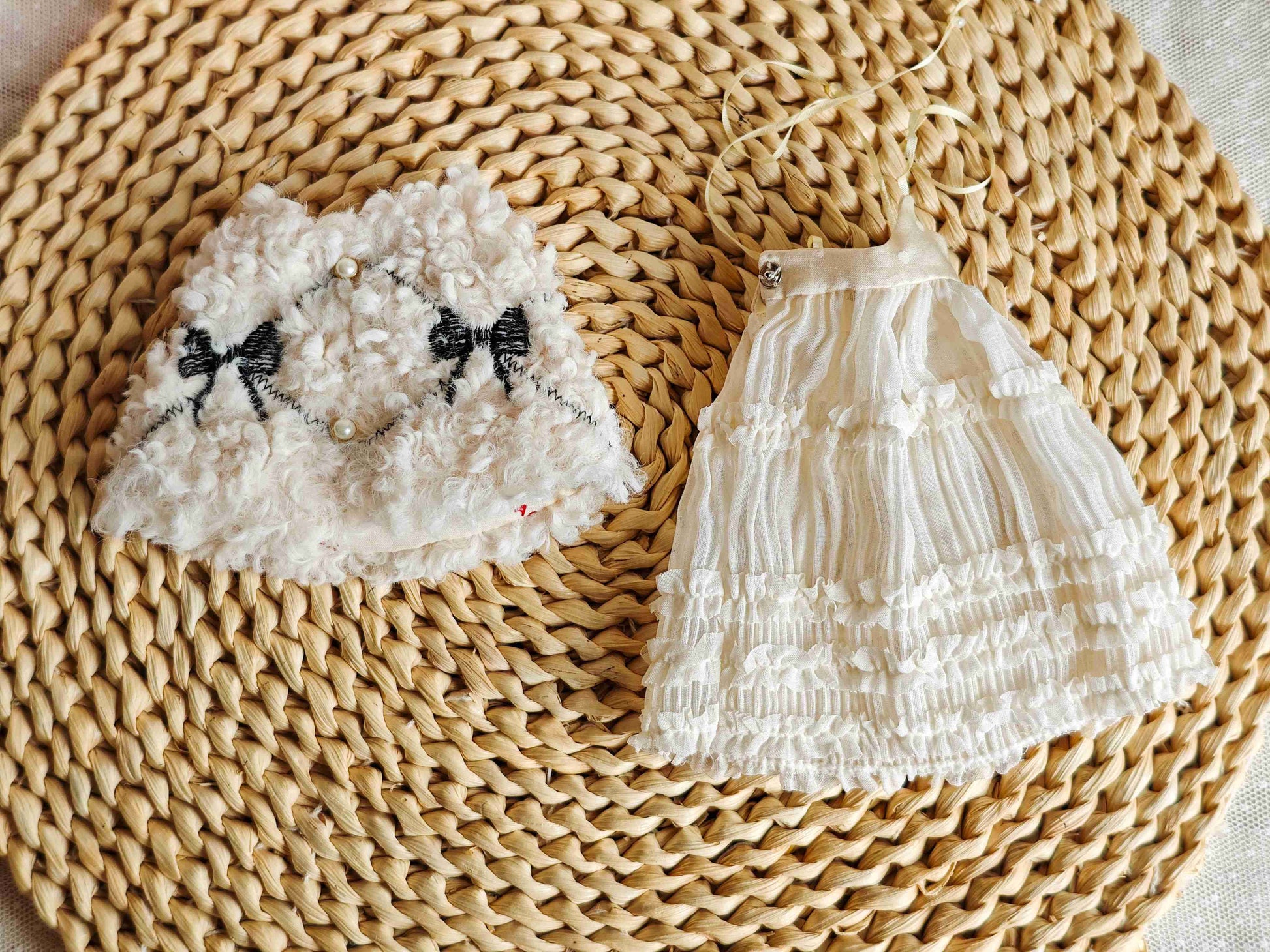 Flat lay product shot of the 2 piece doll outfit including knit camisole dress and white fur cape.