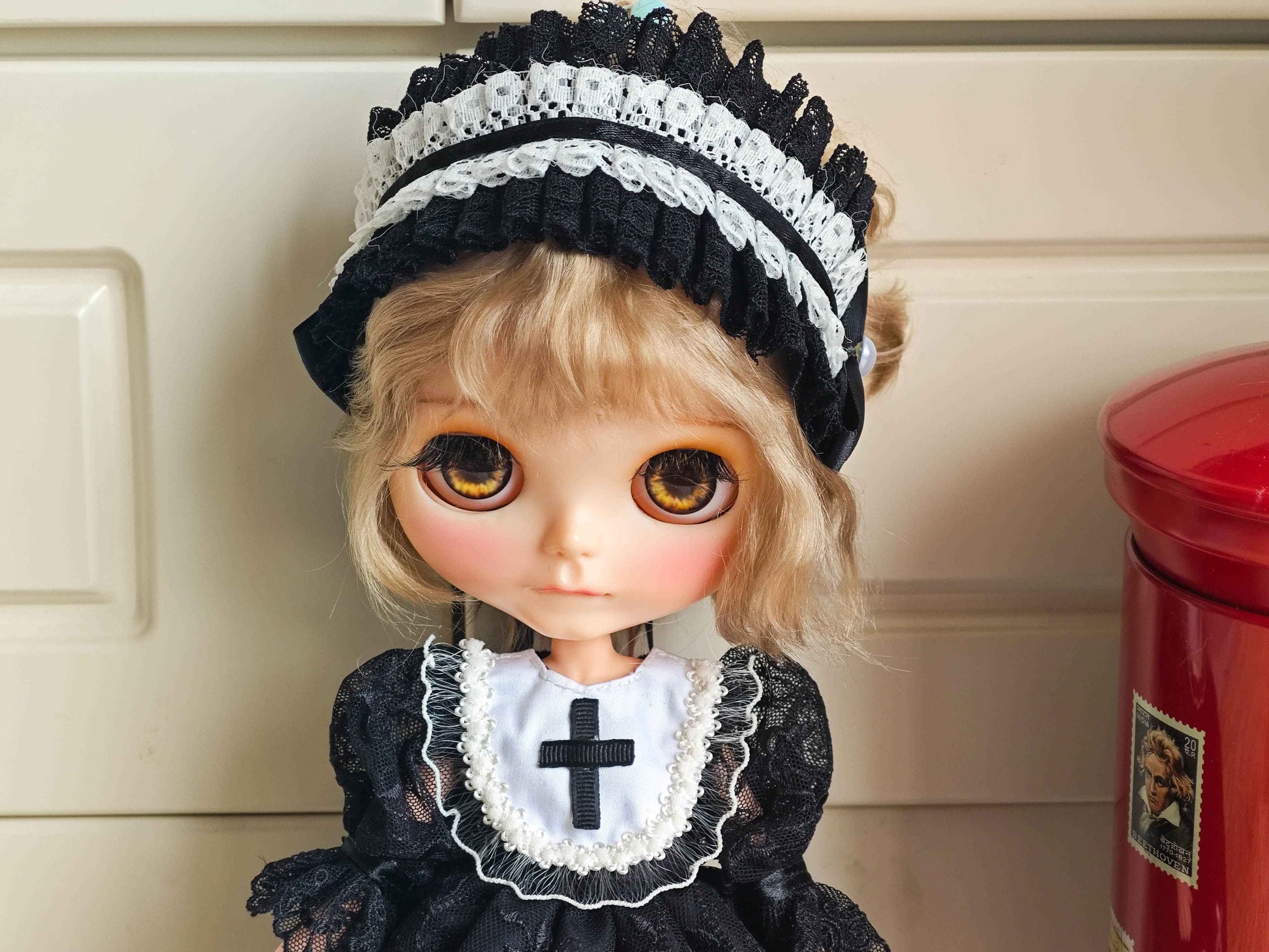 Close up of the high-quality black cross embroidery on the white collar and the intricate headband details.