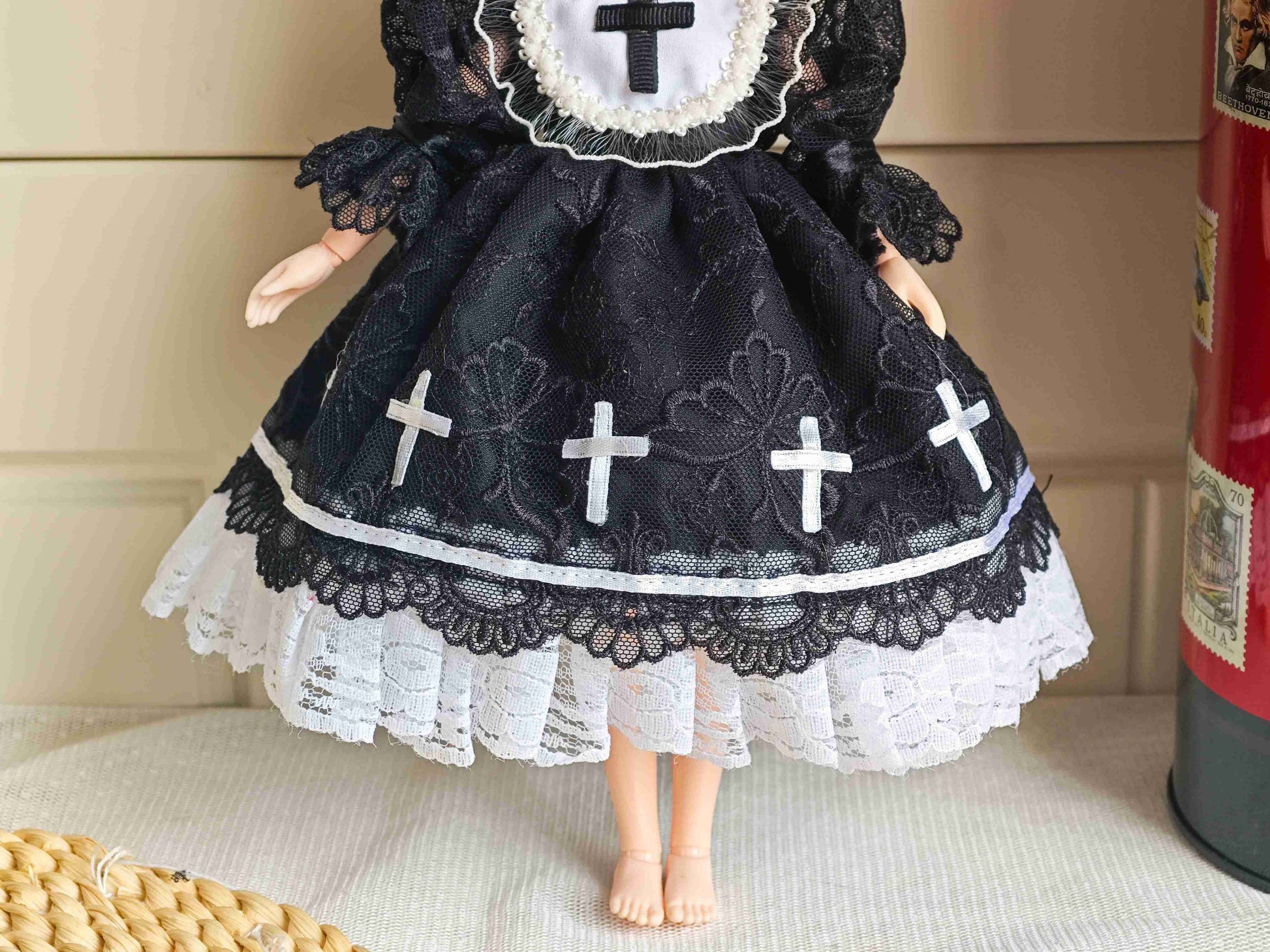 Detailed view of the structured black pleated skirt with clean contrast white layered trim lines.