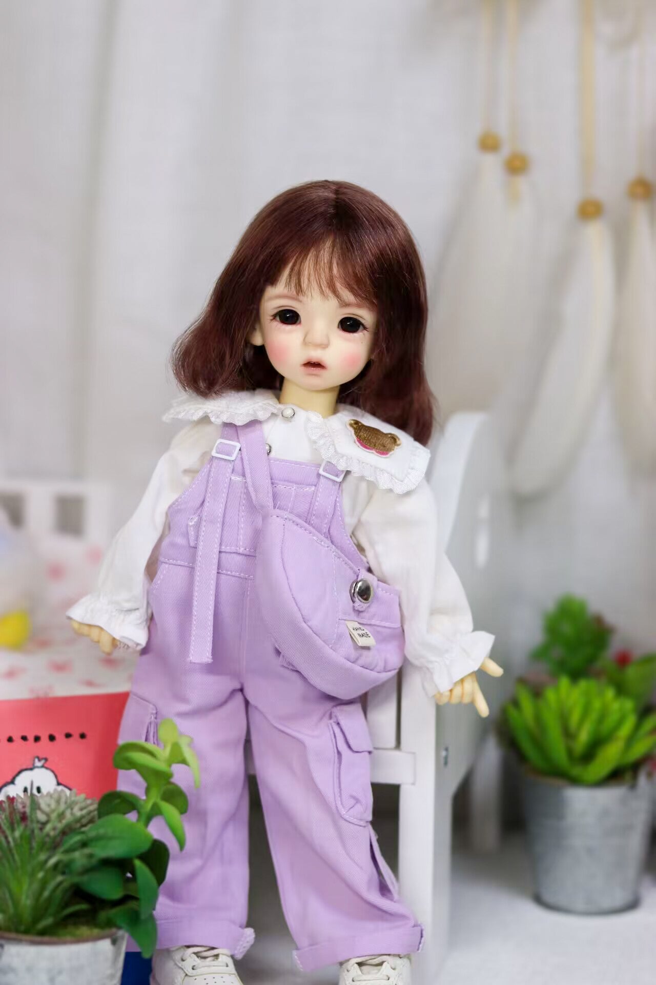 Flat lay product photography of the 4-piece lavender explorer doll outfit featuring the hat, vest, skirt, and matching blouse.