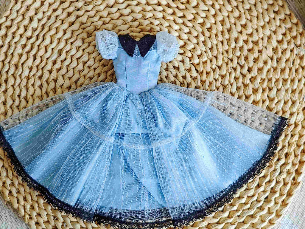 Flat lay product shot of the single piece French vintage layered light blue dress with white overlay.