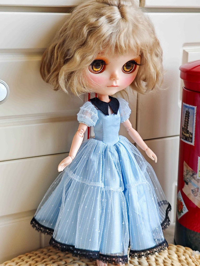 Right side profile of French style romantic layered light blue doll dress with puff sleeves.