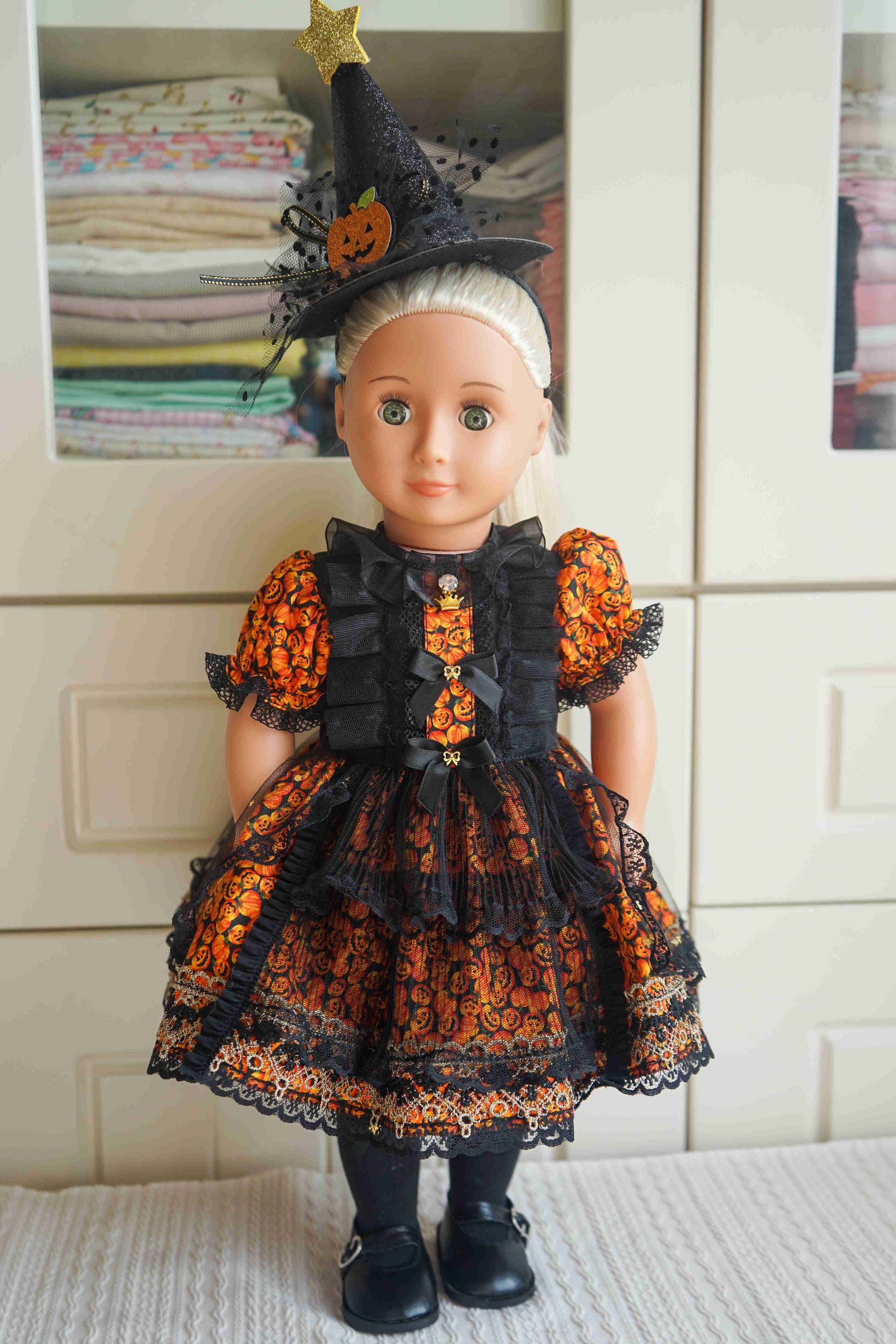 18 inch doll wearing a handmade gothic pumpkin witch Halloween dress set.