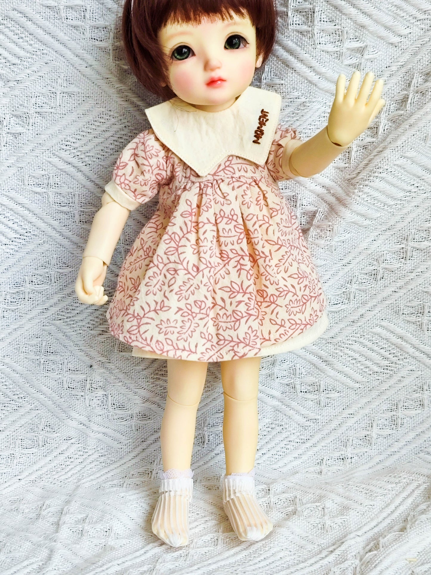 Side view of 1/6 BJD YoSD doll in a handmade leaf print dress.