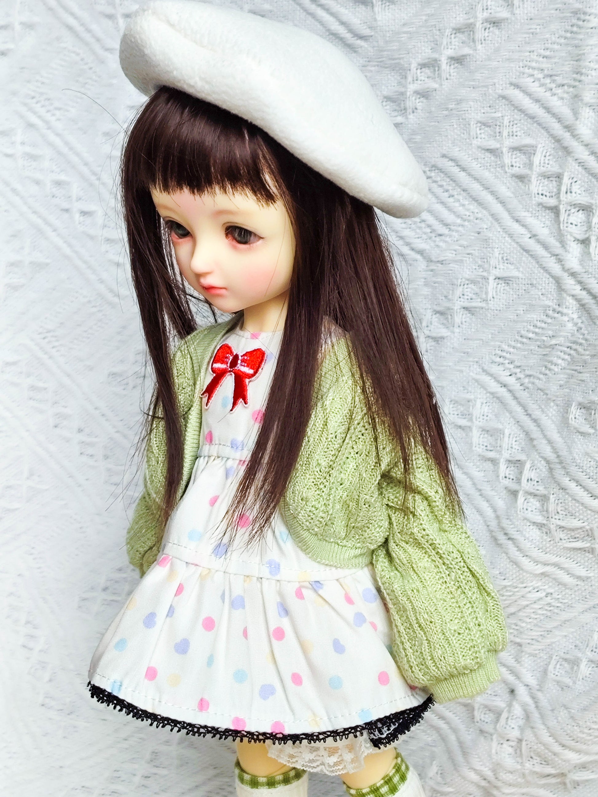 Close up of BJD doll upper body featuring dress, cardigan, and beret.