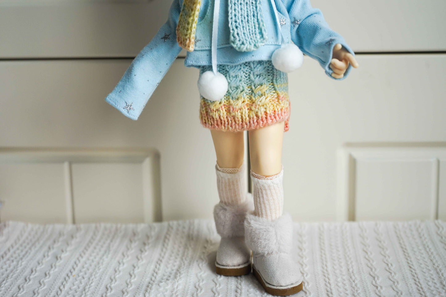 Close up of pastel rainbow knit skirt for 1/6 BJD YoSD doll.