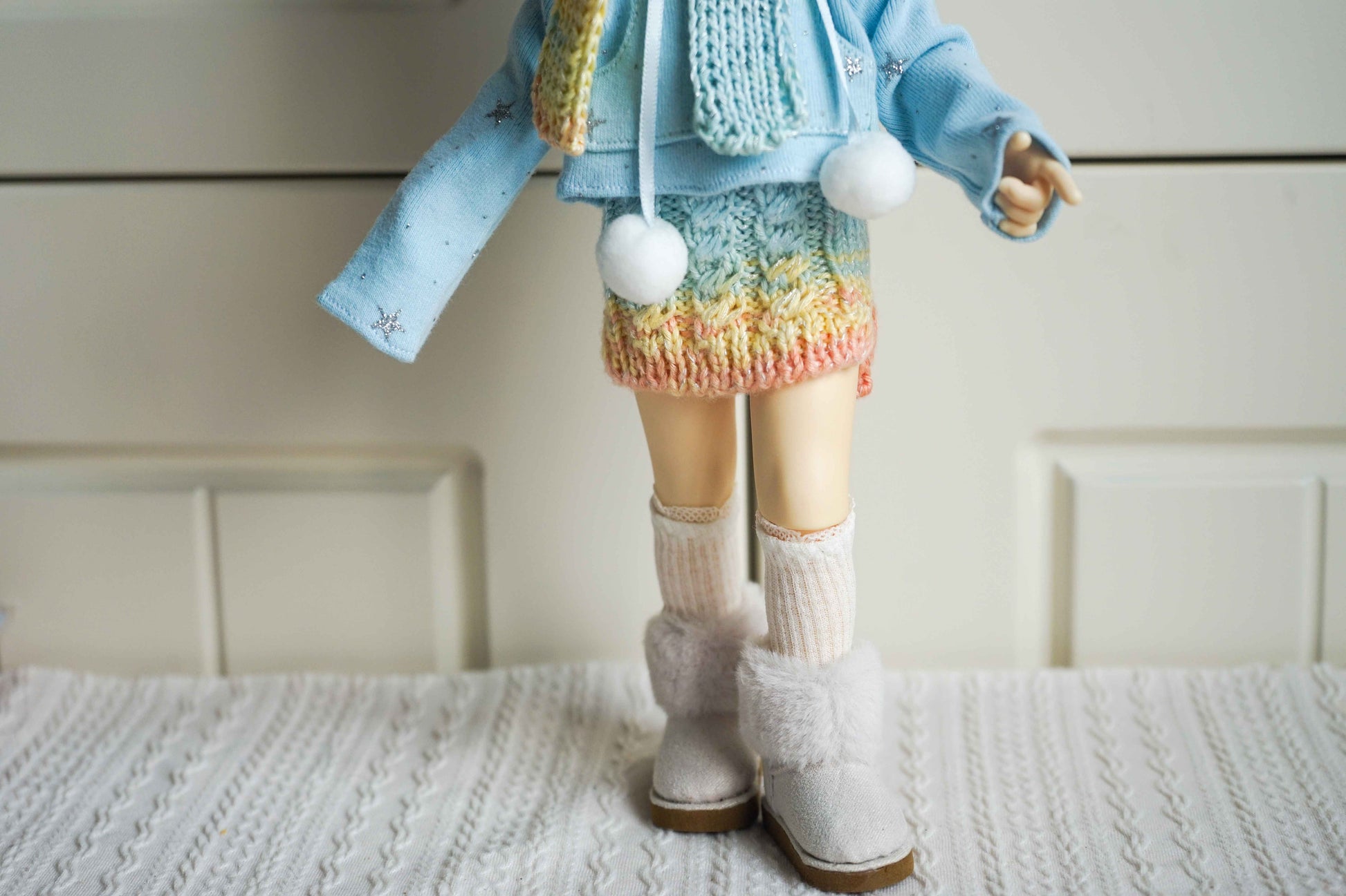 Close up of pastel rainbow knit skirt for 1/6 BJD YoSD doll.
