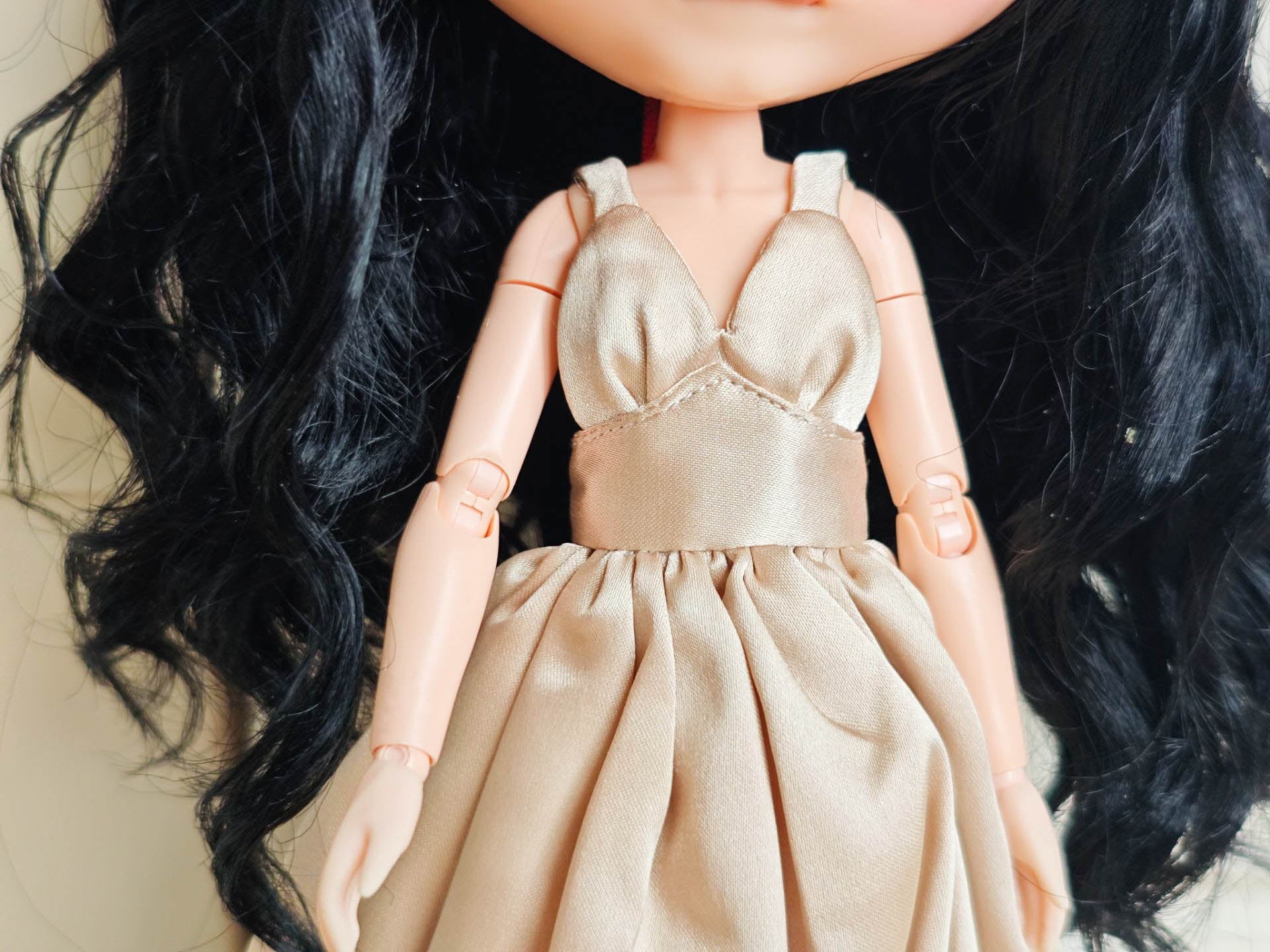 Close-up of the elegant bodice detailing and premium satin texture of the formal doll gown