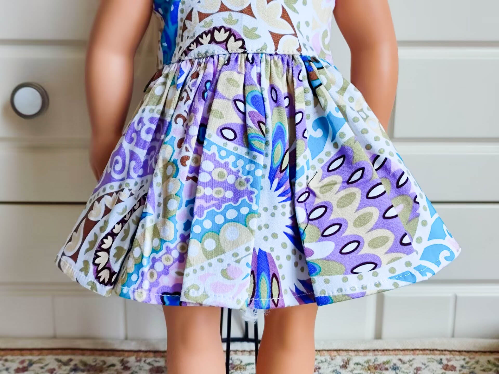 Side view showing the drape and fit of the woodland floral dress for 18-inch dolls.