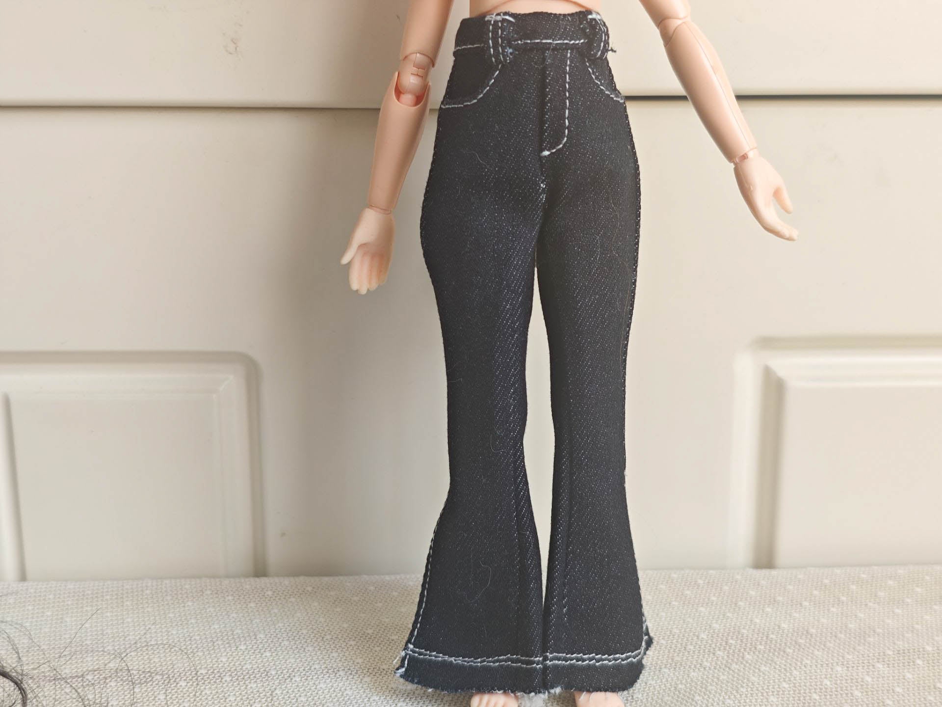 Detailed texture shot showing the quality stitching and denim material.