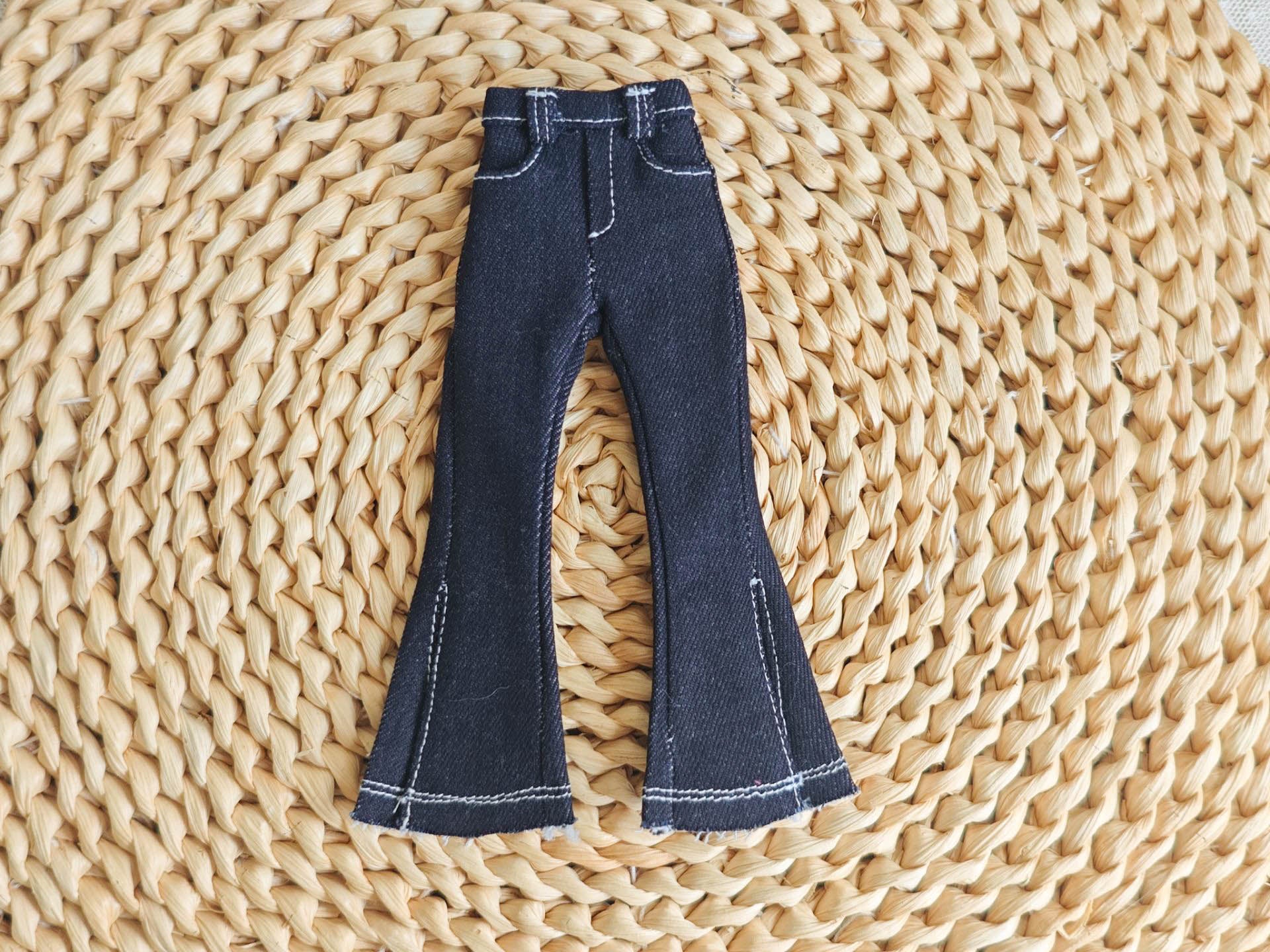 Black Close-up of the high-waisted detailing on the Y2K flared jeans for Blythe.