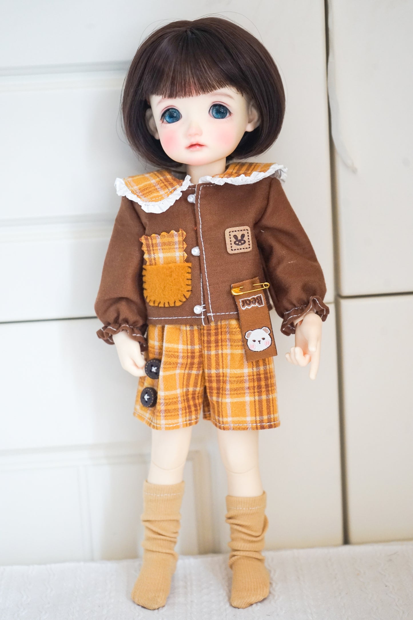 1/6 BJD YOSD doll wearing yellow cat patch shirt and plaid shorts.